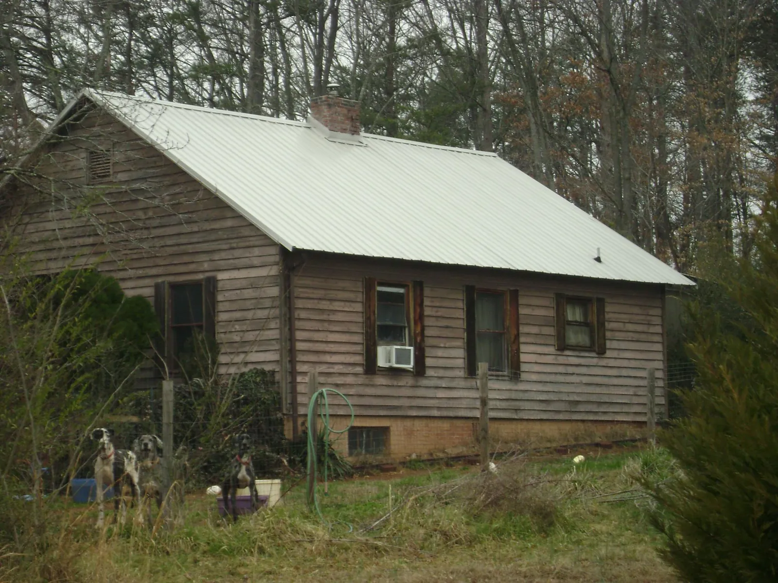 White metal roof on an old wood sided farmhouse, from a Asphalt Shingle Roof Repair job in Harrisburg